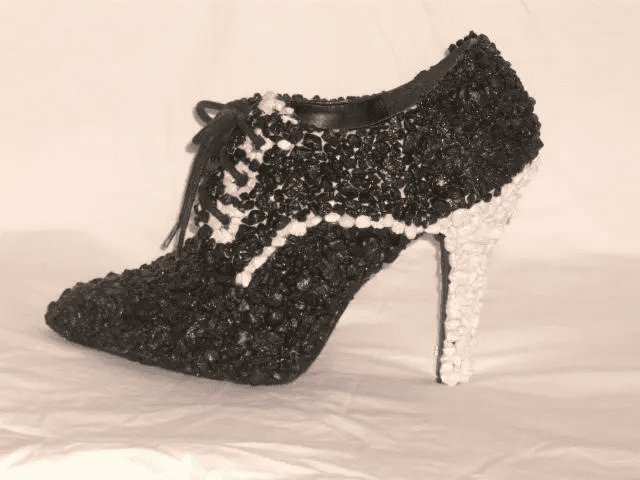 A pair of BLACK AND WHITE SHOE high heeled shoes.