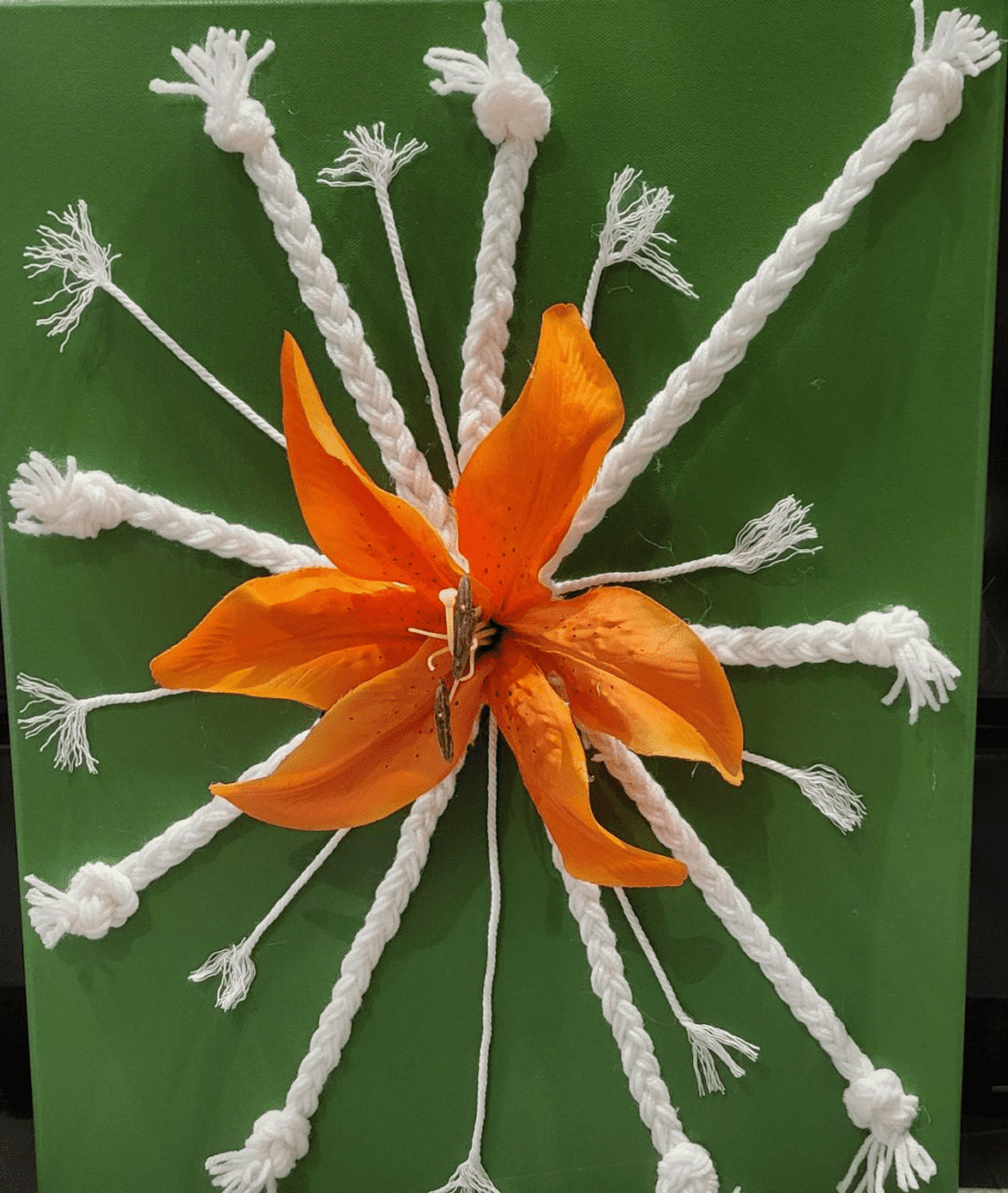 An orange flower with white threads on a GREEN CANVAS  #0045 background.