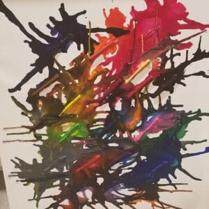 Colorful melted crayons on a white canvas.