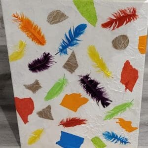 Colorful feathers and paper scraps on canvas.
