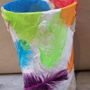 A colorful paper lantern with a feather design.