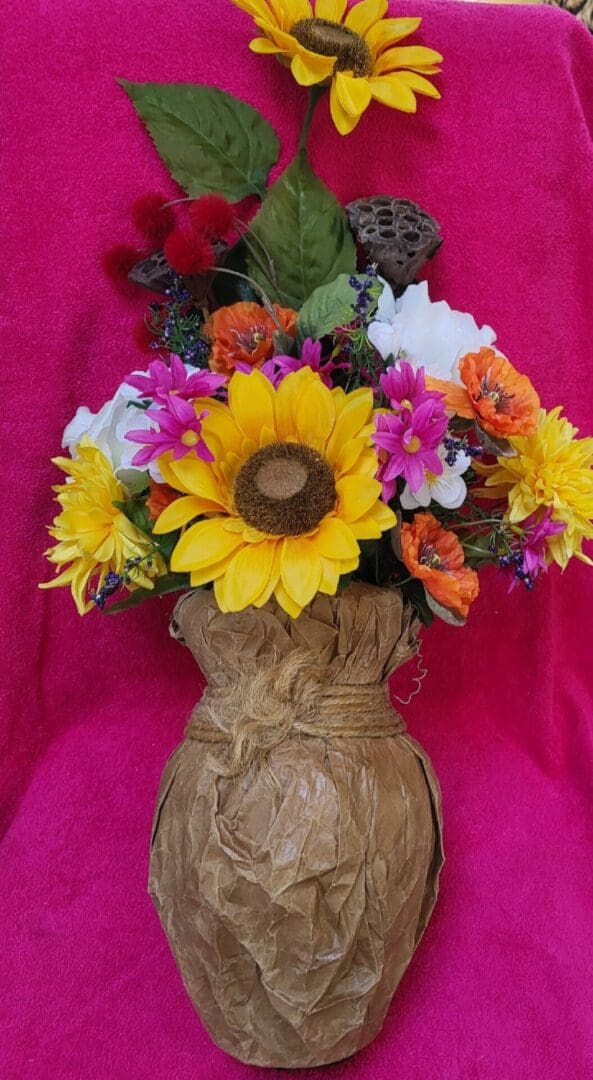 A vase of colorful silk flowers.