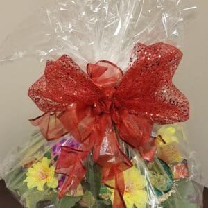 A gift basket with a red bow on top.
